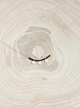 Cargar imagen en el visor de la galería, Collar oro monedas gris, monedas turcas en oro mate de 10x7mm y cristal gris 2mm con cadena sencilla 0,7mm bañada en oro y 37 cm de largo con extensión.