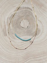 Cargar imagen en el visor de la galería, Collar oro doble turquesa con cristal turquesa de 2mm y con cadena con bolas intercalada 2mm bañada en oro y 39 cm de largo y extensión.